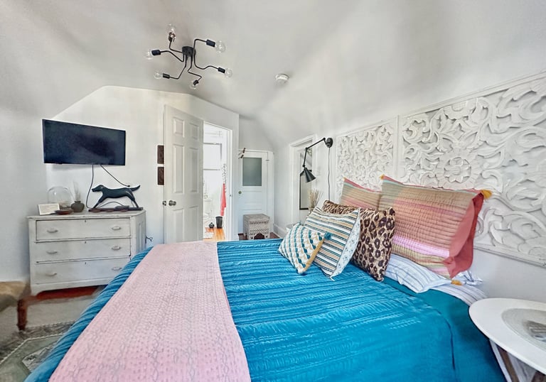 a bedroom with a bed and a television