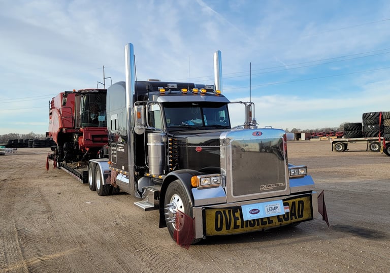 a semi truck with a large trailer parked in a lot