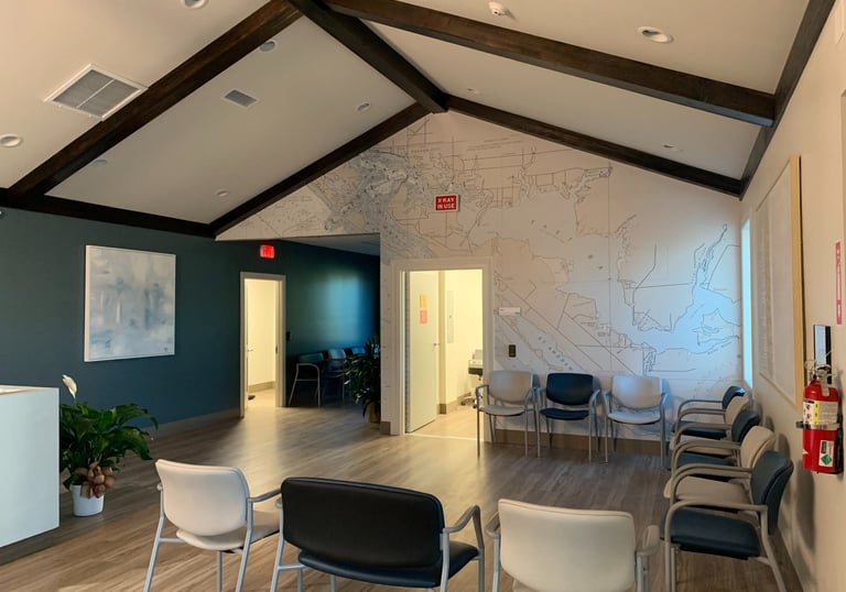 commercial office construction showing a waiting room with chairs and a map of a map
