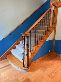 Rebuilt handrails with new balusters, carpeted stairs, installed new hardwood floors