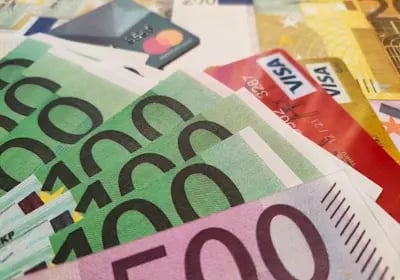 Spread of euro banknotes and credit cards — showcasing Binance’s easy fiat on-ramps with Visa etc