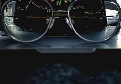 Glasses with crypto chart showing best value for traders and investors