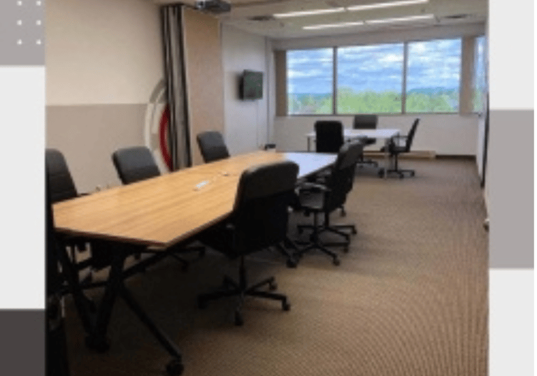 a conference room with a table and chairs