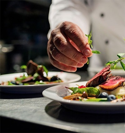 un chef prépare deux assiettes de salade