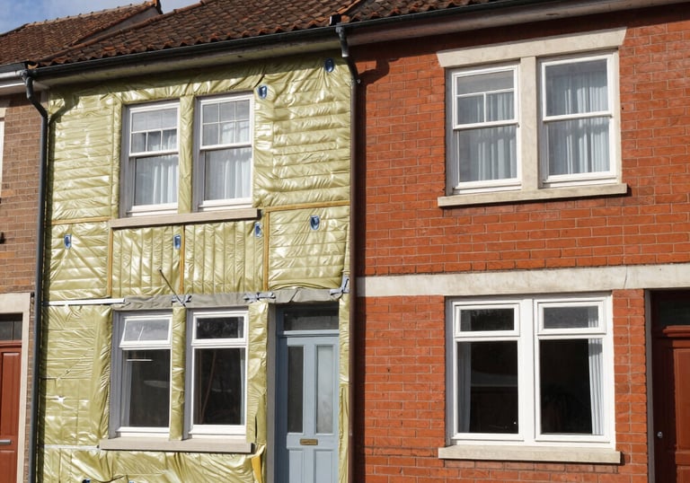 A modern building undergoing eco-friendly retrofitting with scaffolding and green materials.