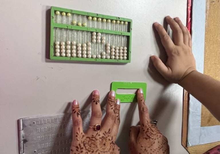 Image of two hands feelingtactile elements of study material for visually impaired