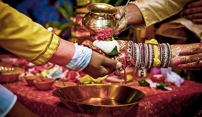 Pandit ji performing puja at the time of phere in hindu marriage