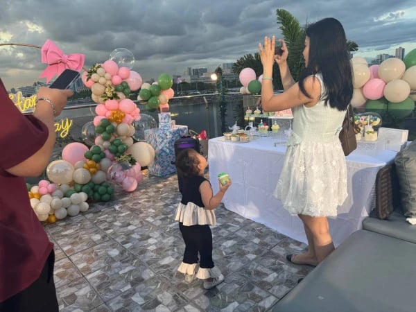 a woman is taking a picture of a young girl