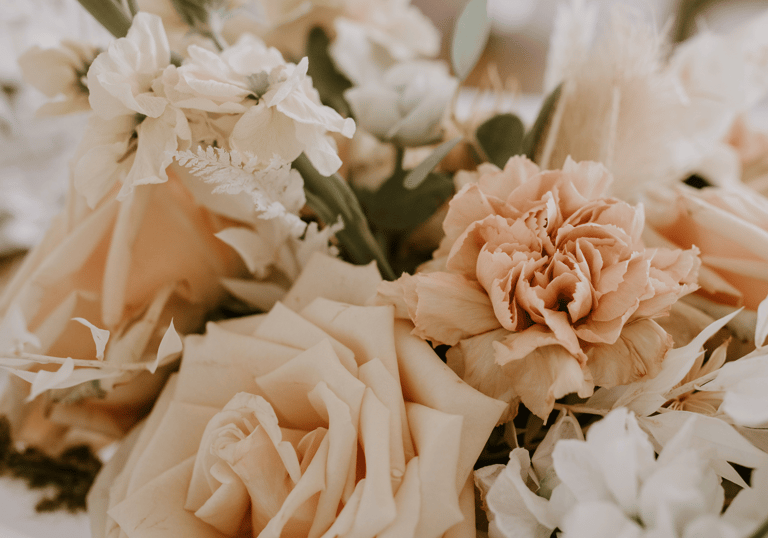 a bouquet of flowers in a vase on a table