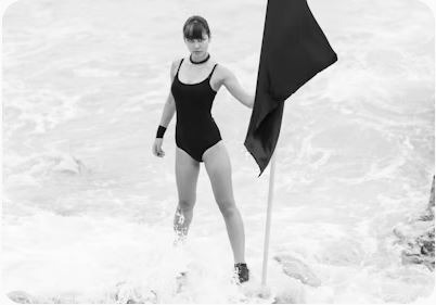 woman in black one piece swimsuit holding umbrella