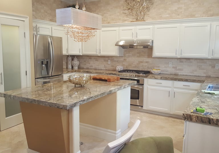 Refinished kitchen cabinetry from brown wood to white lacquer