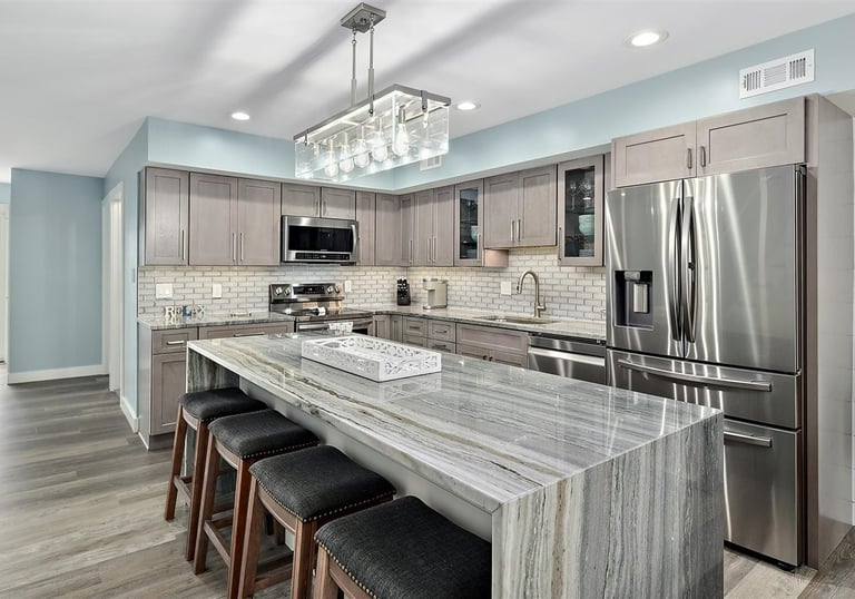 a kitchen with a marble counter top and a chandelier