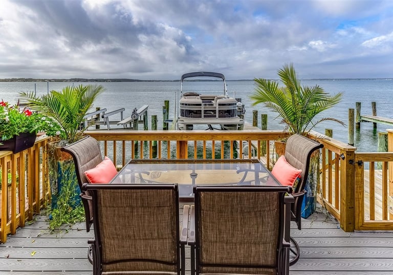 a table with chairs and a boat dock
