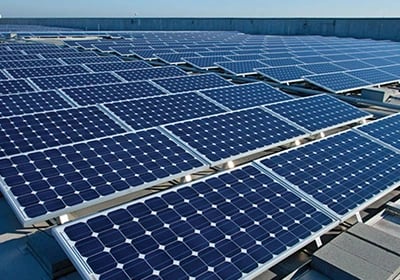 Photovoltaic solar panels installed on a flat commercial rooftop for renewable energy production.