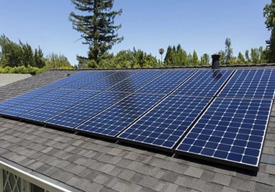 A residential rooftop solar panel installation for renewable energy efficiency on a sunny day.