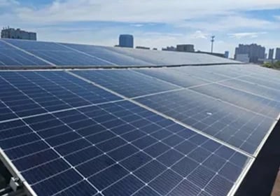 Residential rooftop solar panel installation on a tan tile roof for clean renewable energy.