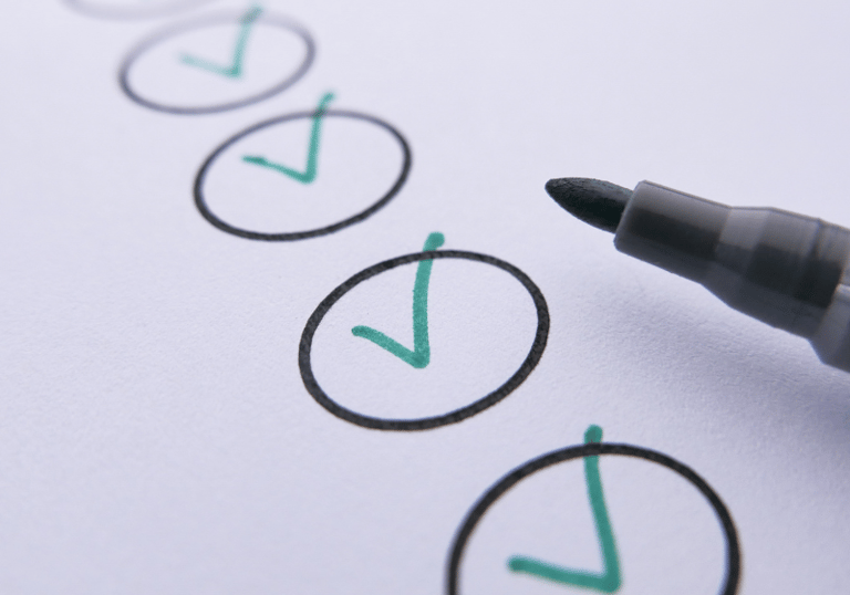 A pen and several circles of a checklist ticked off.