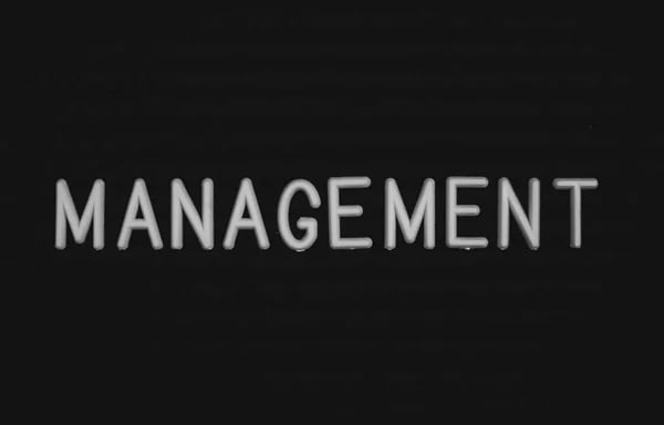 a black and white sign that says management