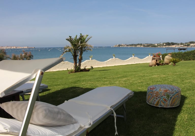 Garden with sun loungers and panoramic sea view of Ortigia, Siracusa, Sicily, Villa Incanto on the Sea