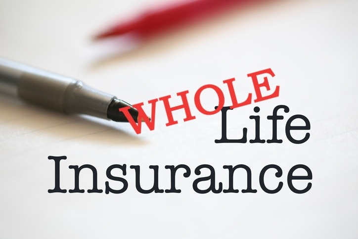 a pen and a pen on a paper with the words whole life insurance