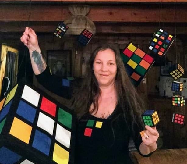 a woman holding a rubt cube puzzle puzzle