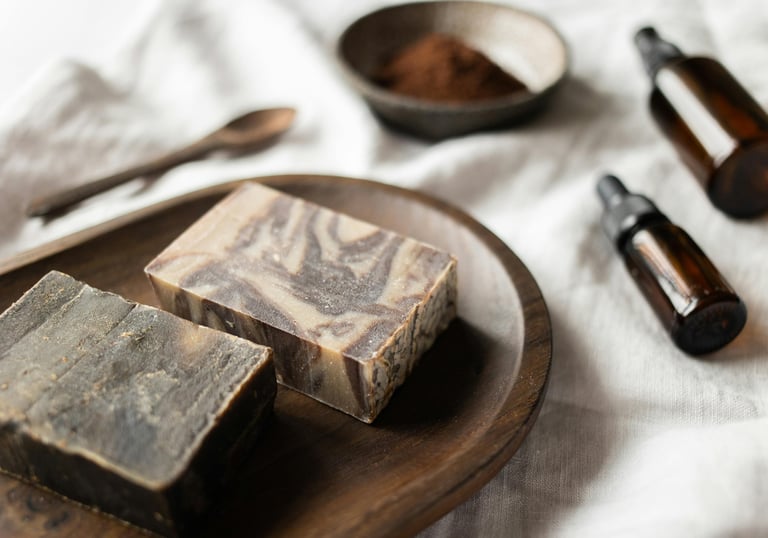 Handcrafted goat milk soap bars on a wooden dish with natural ingredients and essential oils