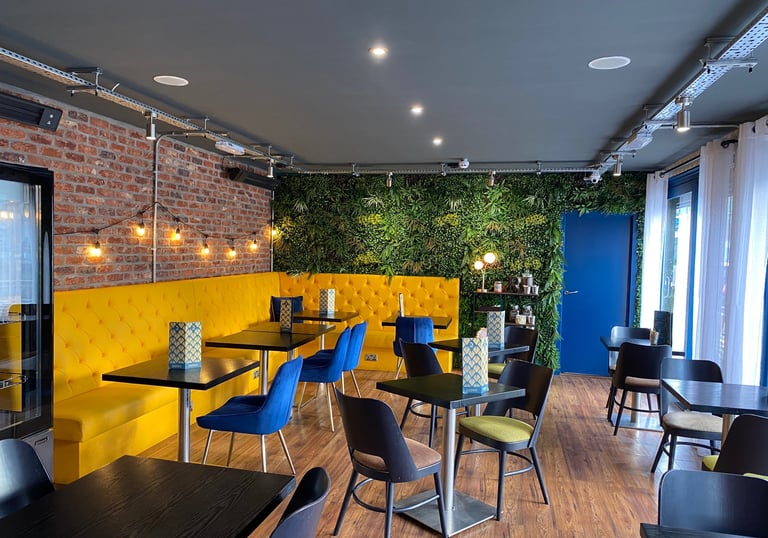 inviting cafe setting with bright yellow and blue seating 