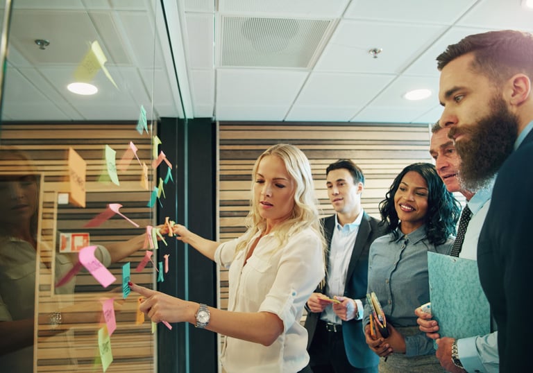 A team brainstorming with sticky notes during an innovation workshop.