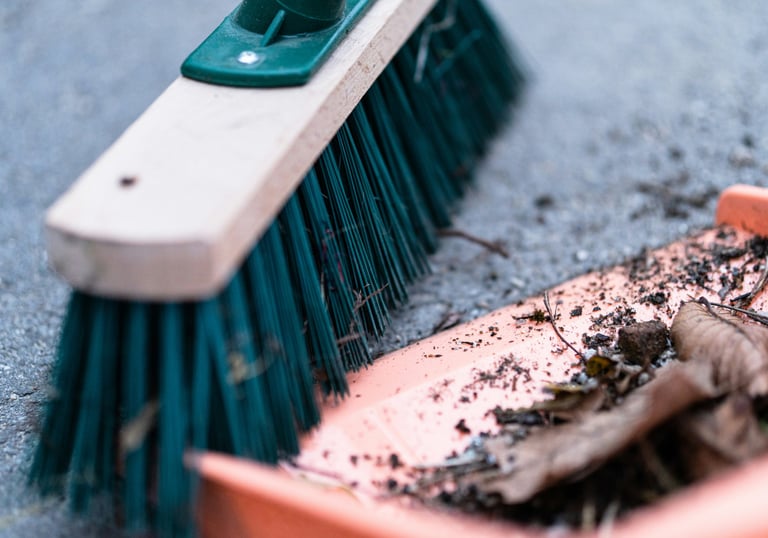 Broom sweeping debris