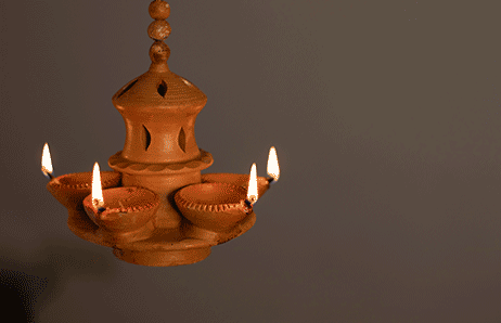 a clay potted with candles and candles