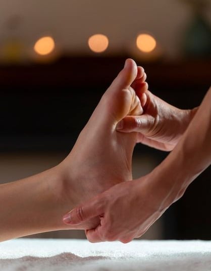 a person's foot and foot in a massage room