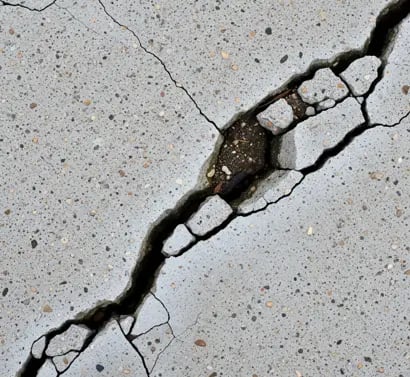 a crack in the concrete floor of a parking lot