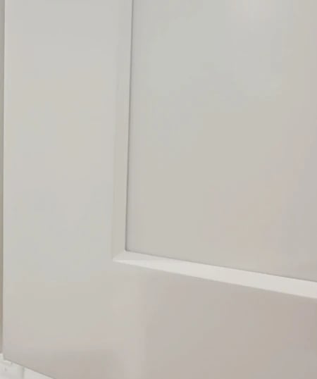 Close-up of white shaker cabinet with angled edge profile or Euro-Style