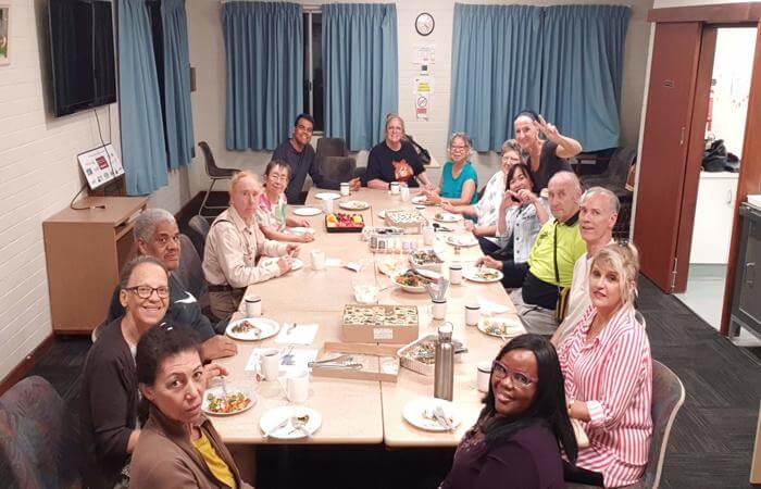 a group of people sitting around a table sharing meals
