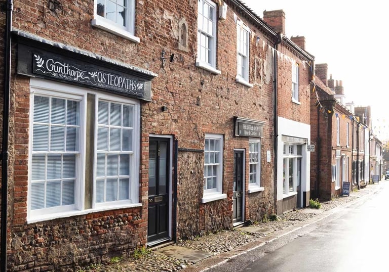 a street scene with a brick building and a sign that says,'the sign