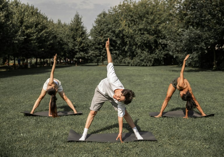 a small group of people doing exercise in a park
