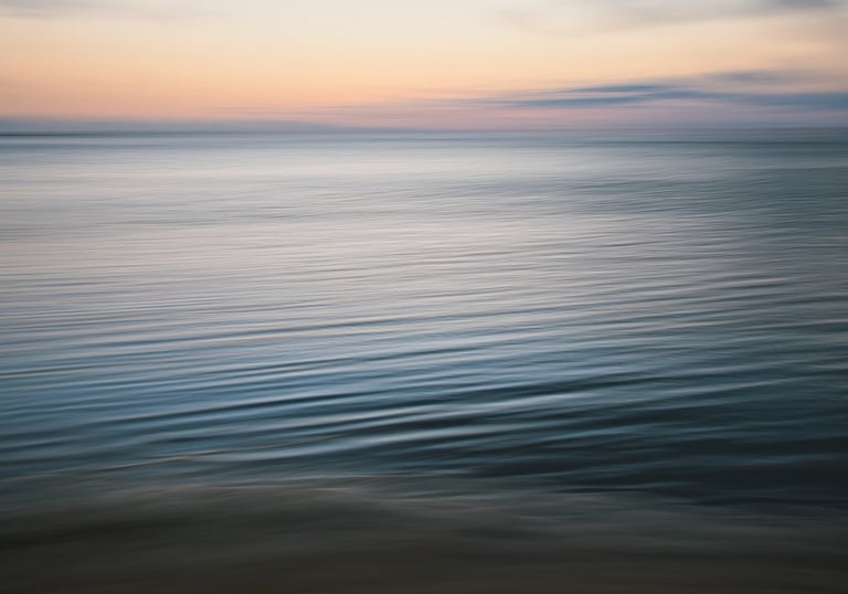 Soft waves shot in ICM on a calm ocean at sunset in Mauritius with gentle pastel hues