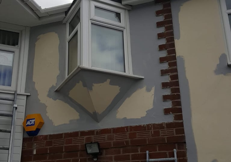 a house exterior being primed for painting