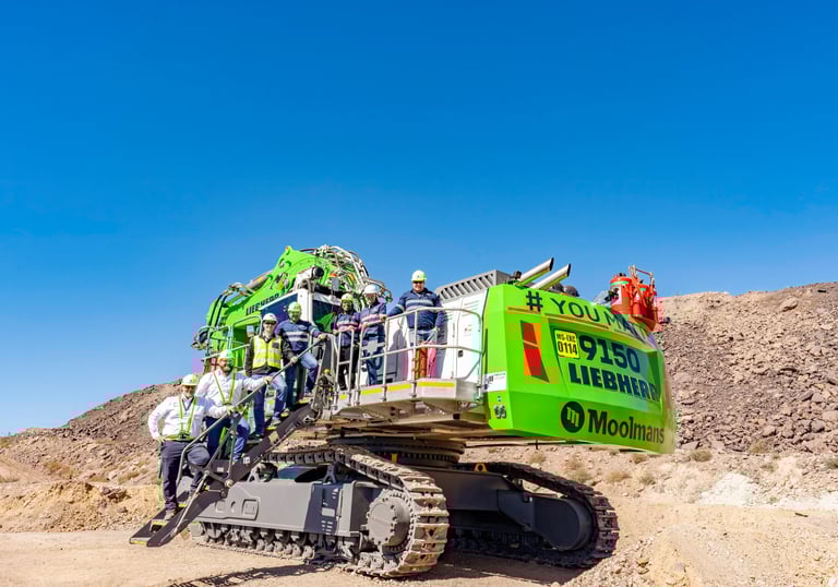 mining excavator with people posing on it