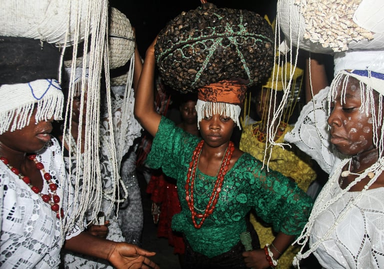 A woman in a green dress with a large basket on her head