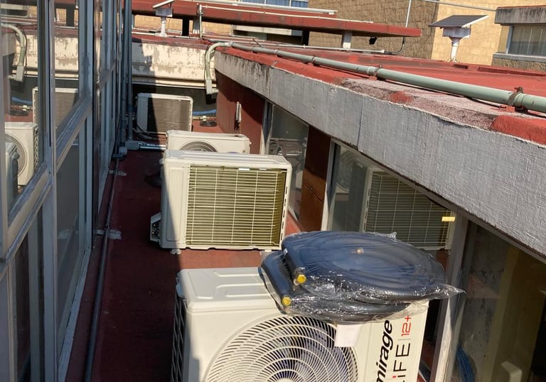 a couple of air conditioners sitting on a roof top