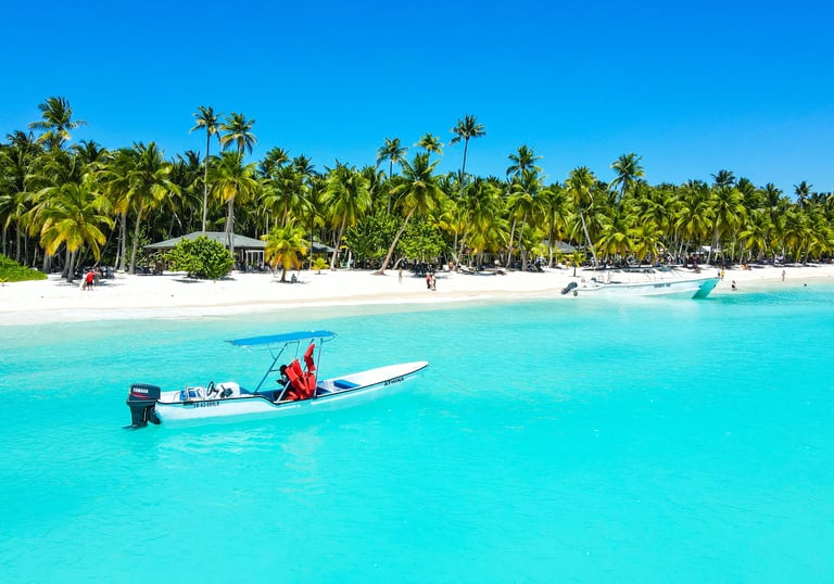 a boat in the water with people on the beach saona island