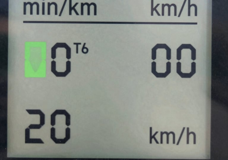 a man riding a skateboard down a street next to tall buildings