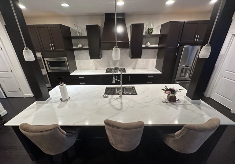 Overhead view of kitchen island featuring new quartz countertops with brown veins.