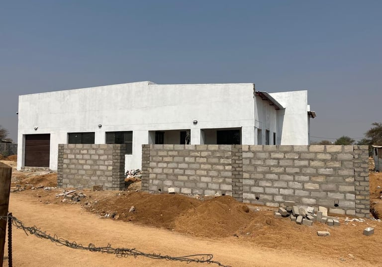 a house with a fenced in area with a fence House Construction Frans-del Investment CC Construction c