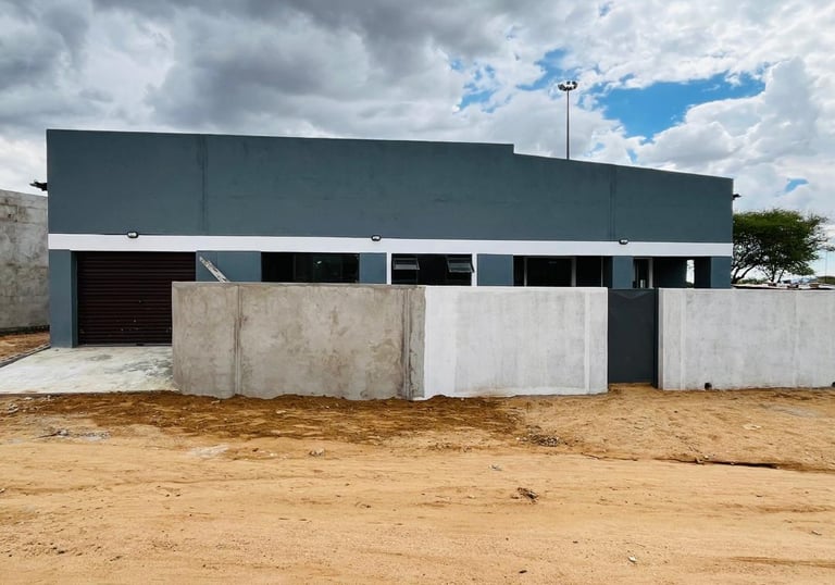 a building with a garage door and a garage door, House Construction Frans-del Investment CC Construc