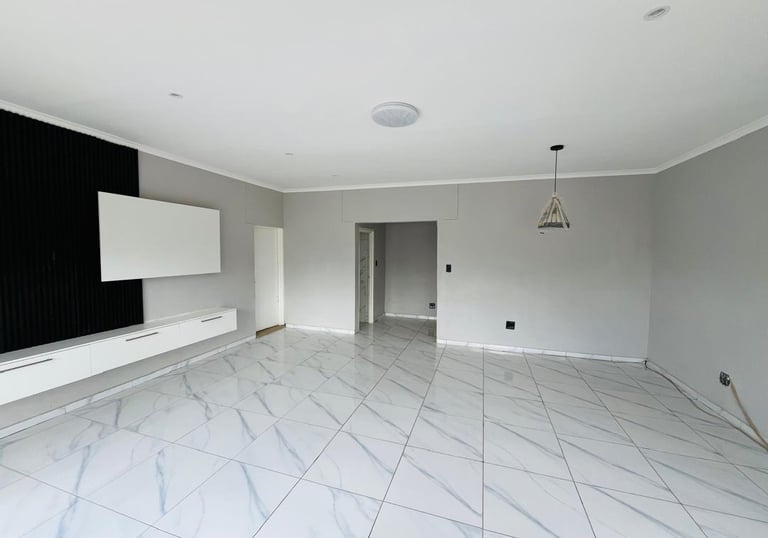 a room with a television and a flat screen TV, House Construction Frans-del Investment CC Constructi