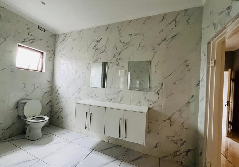 a bathroom with a toilet and a toilet paper roll, House Construction Frans-del Investment CC Constru