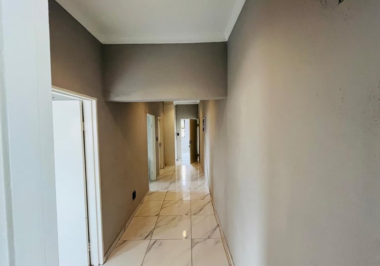 a hallway with a marble floor and a marble floor, House Construction Frans-del Investment CC Constru