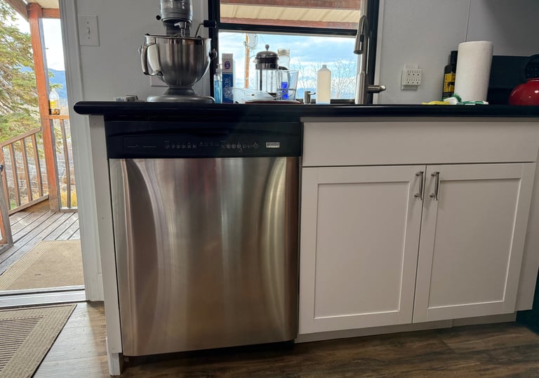 Frigidaire dishwasher installation by Cherry Home Service – modern kitchen setup with scenic mountai
